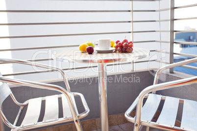 fruits and tea on the table on the balcony