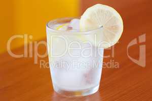 water with ice and lemon on the table