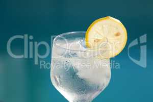 Swimming pool and wine glass with ice and lemon