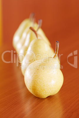 pears lying on a wooden table