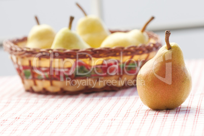 pears in a wooden basket  lying on a plaid fabric