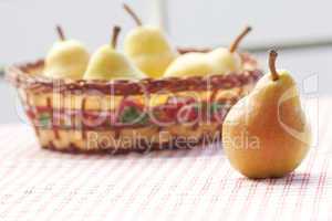 pears in a wooden basket  lying on a plaid fabric