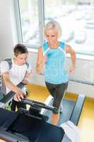 Young fitness instructor woman running at gym