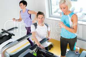 Young fitness instructor woman running at gym