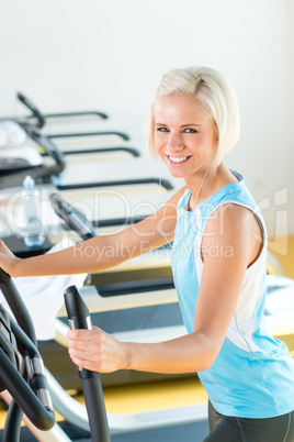 Fitness young woman on elliptical cross trainer