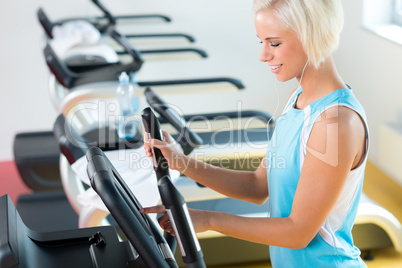 Fitness young woman on elliptical cross trainer
