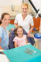 Dental team in stomatology clinic with child