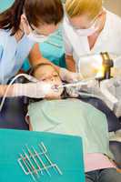 Dentist and assistant with child patient