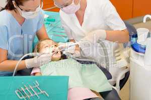 Dentist and assistant with child patient