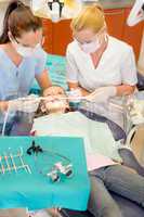 Dentist with nurse doing procedure on child