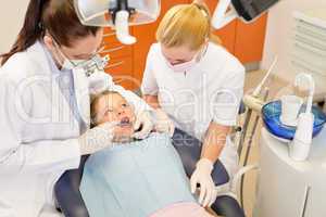 Dental assistant with dentist and little child