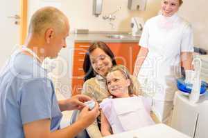 Child visit dentist surgery with mother