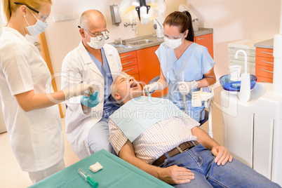 Senior man at dentist surgery have treatment
