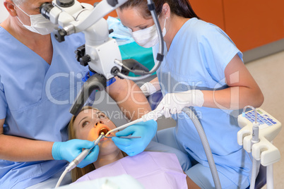 Dentist operation patient through microscope