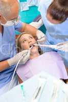 Dentist with nurse doing procedure on patient
