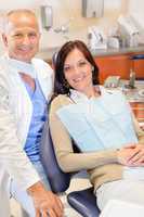 Dentist and female patient at surgery office