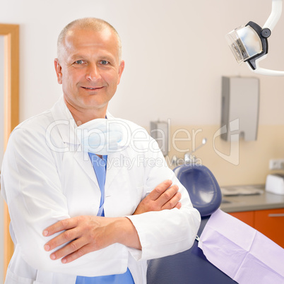 Mature dentist surgeon at office