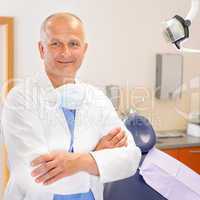 Mature dentist surgeon at office