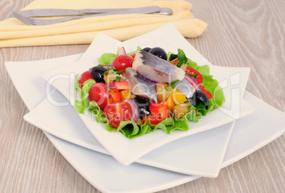 Appetizer of herring and vegetables with croutons