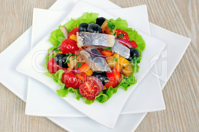 Appetizer of herring and vegetables with croutons