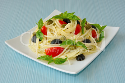 Spaghetti with tomato, capers and basil with olives