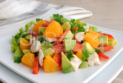 Chicken salad with avocado, sweet pepper and orange