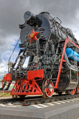 Ancient steam locomotive with red star