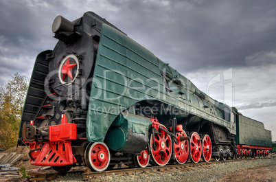 Ancient steam locomotive with red star