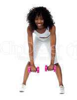 Fit woman exercising. Bending down
