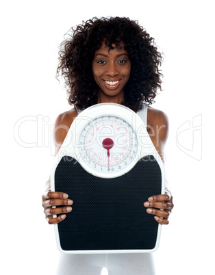 African athlete showing weighing scale