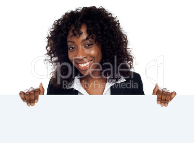 Young woman holding blank white placard