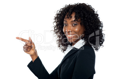 Corporate woman indicating towards copy space