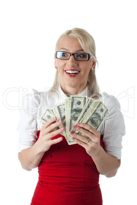 Happy blond business woman in red with money