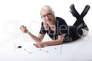 Cute blond business woman draw financial graph