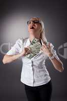 blond businesswoman hide money under shirt