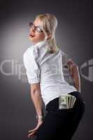 young blond woman show money in jeans