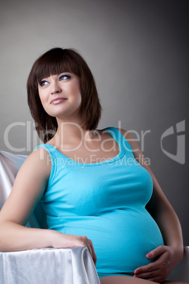 Happy pregnant woman in studio