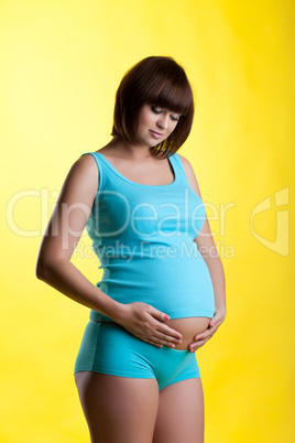Pretty pregnant brunette young woman