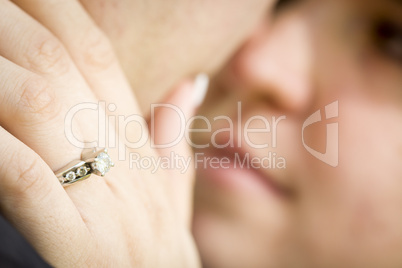 Female Hand with Engagement Ring Touching Fiance's Face