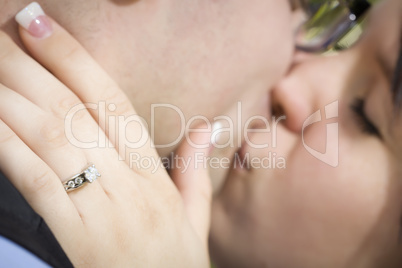 Female Hand with Engagement Ring Touching Fiance's Face