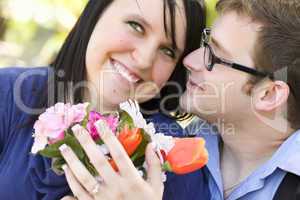Attractive Young Man Gives Flowers to His Love