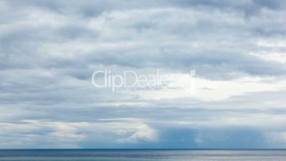 moving grey clouds over sea horizon time lapse