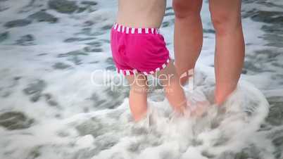 Mother and Daughter Enjoying in The Waves