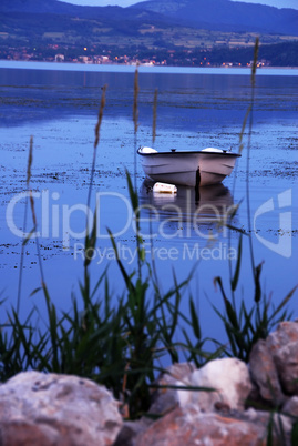 Lonely boat on blue river