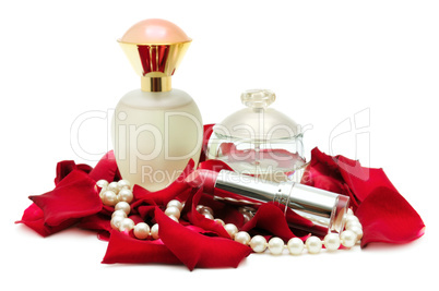 Perfume and pearl necklace in rose petals