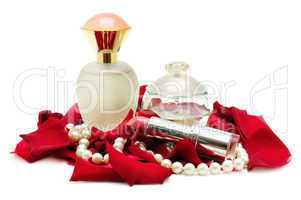 Perfume and pearl necklace in rose petals