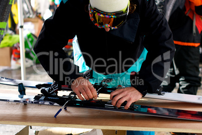 Man adjusting skis