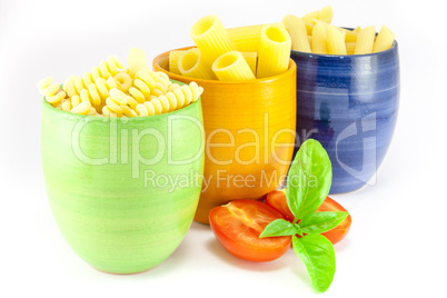 Fusilli, rigatoni and pens pasta in a green, blue and orange jar