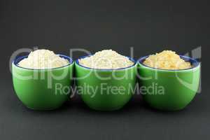 Three varieties of rice in three small green cups