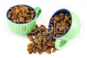 Two coffee cups full of raisins